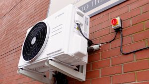 Image of a condenser unit outside a building that has just had their air conditioning installed by RJ Martindale