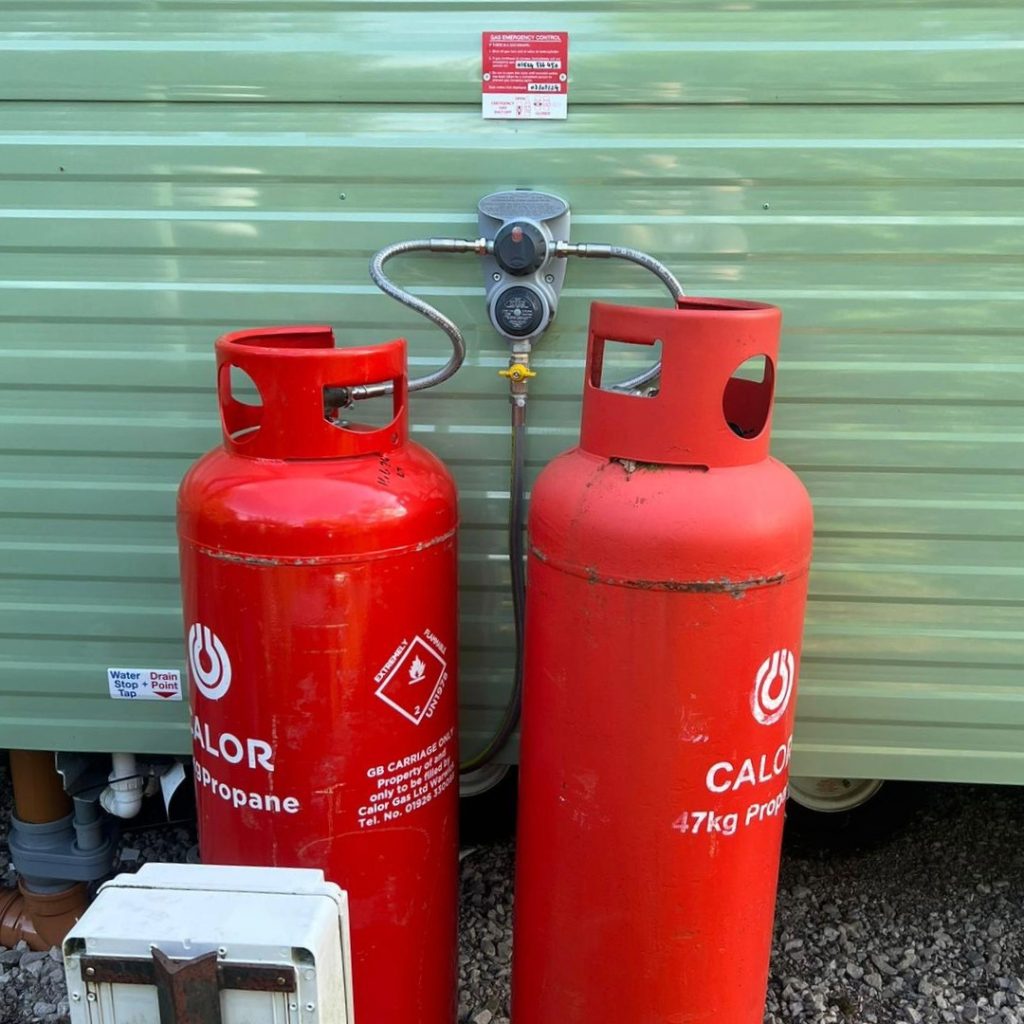 Two LPG canisters attached to a caravan at a holiday home